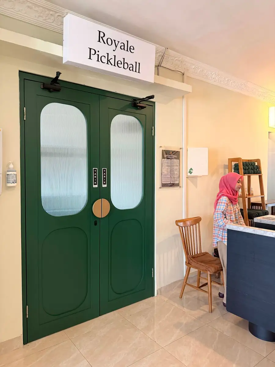 The green double doors to the Royale Pickleball court