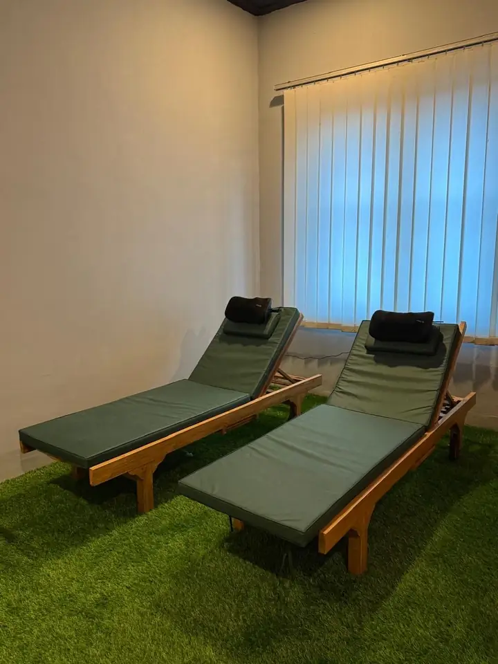 Green massage day beds by the window